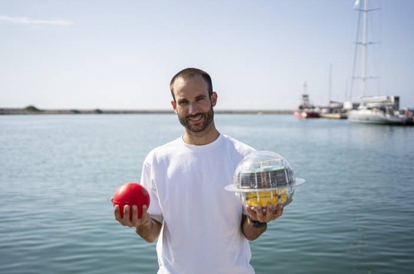 Portrait of Matias Carandell with two buoys